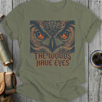 T-shirt with owl eyes and text "The Woods Have Eyes".