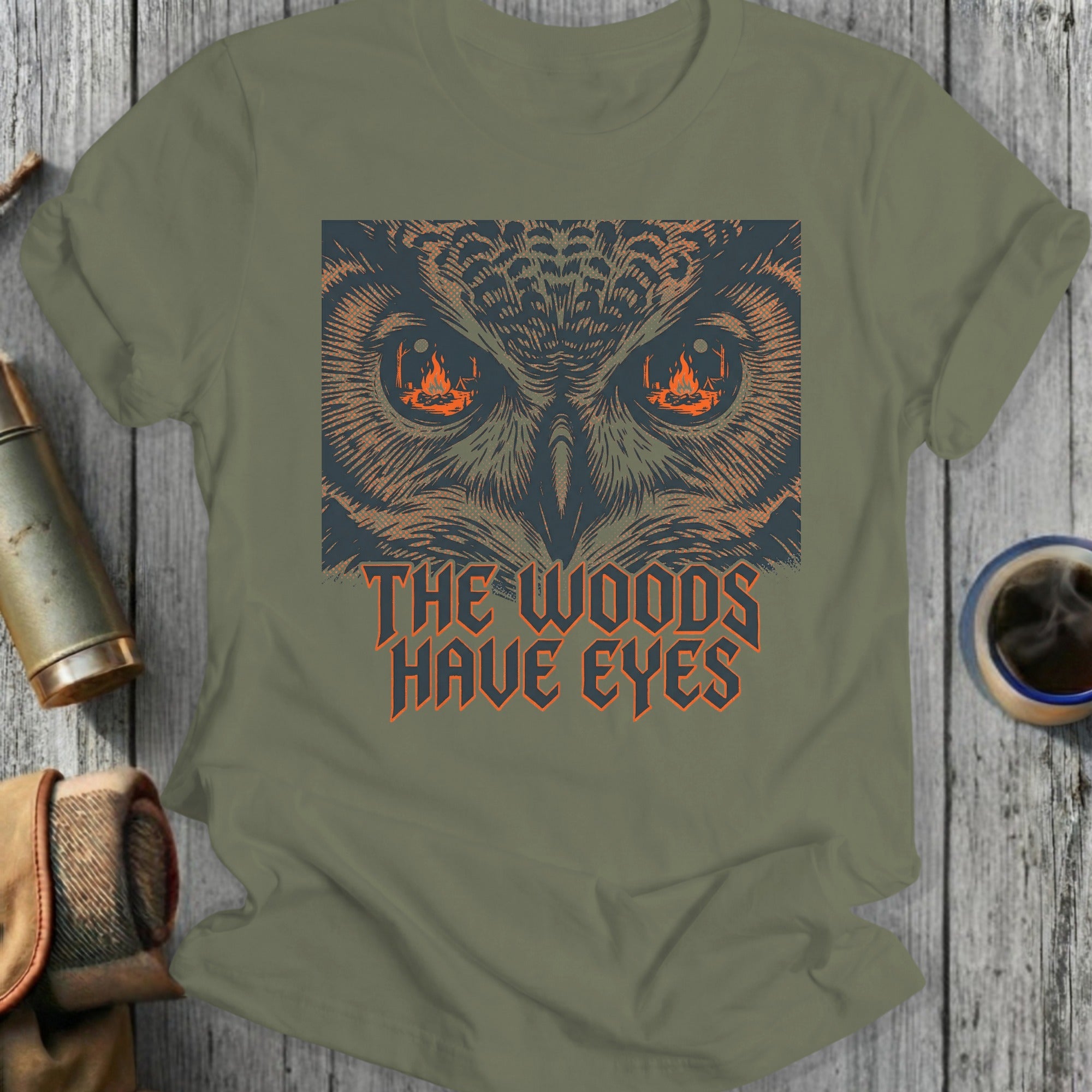 T-shirt with owl eyes and text "The Woods Have Eyes".