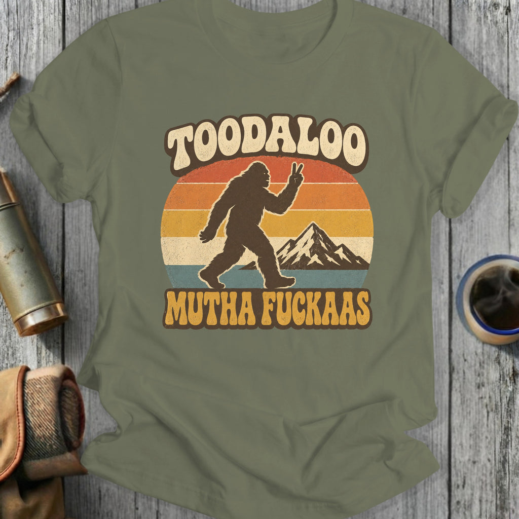 Bigfoot silhouette with peace sign and mountains, reads "TOODALOO MUTHA FUCKAAS".