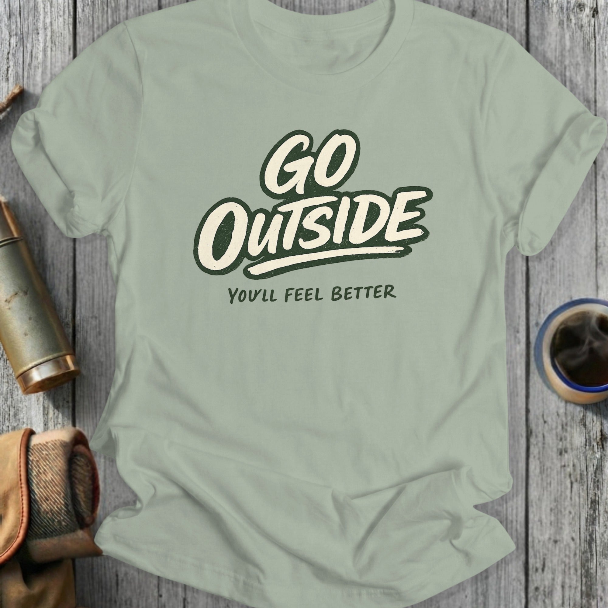 Light sage t-shirt with "GO OUTSIDE YOU'LL FEEL BETTER" text.