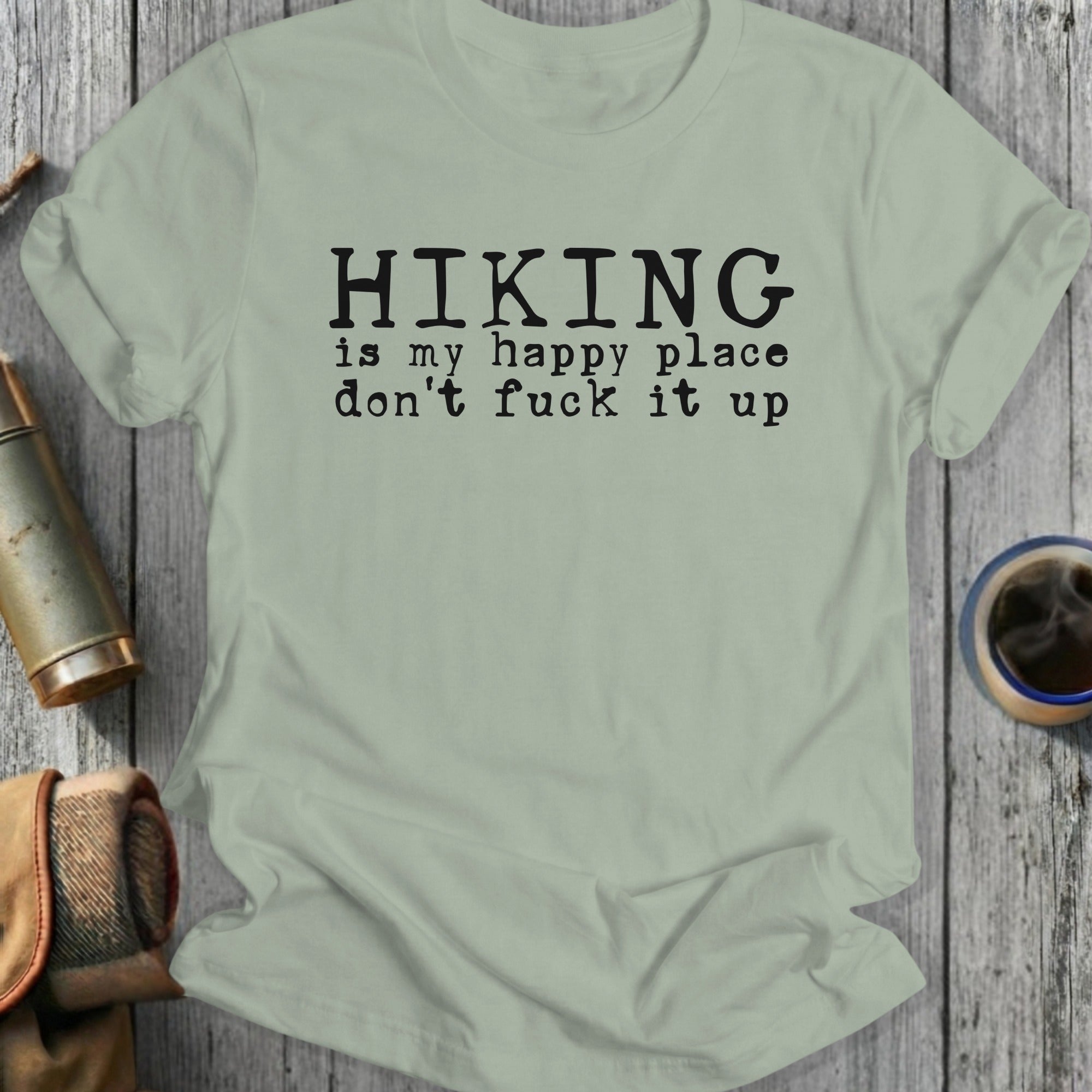 Light green t-shirt with black text that reads "Hiking is my happy place don't fuck it up".