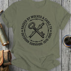 T-shirt with vintage key, barbed wire, and text: Raised by Wolves & Cable TV Outdoor Survivor.