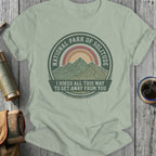 Green t-shirt with circular National Park of Solitude design and mountain graphic.