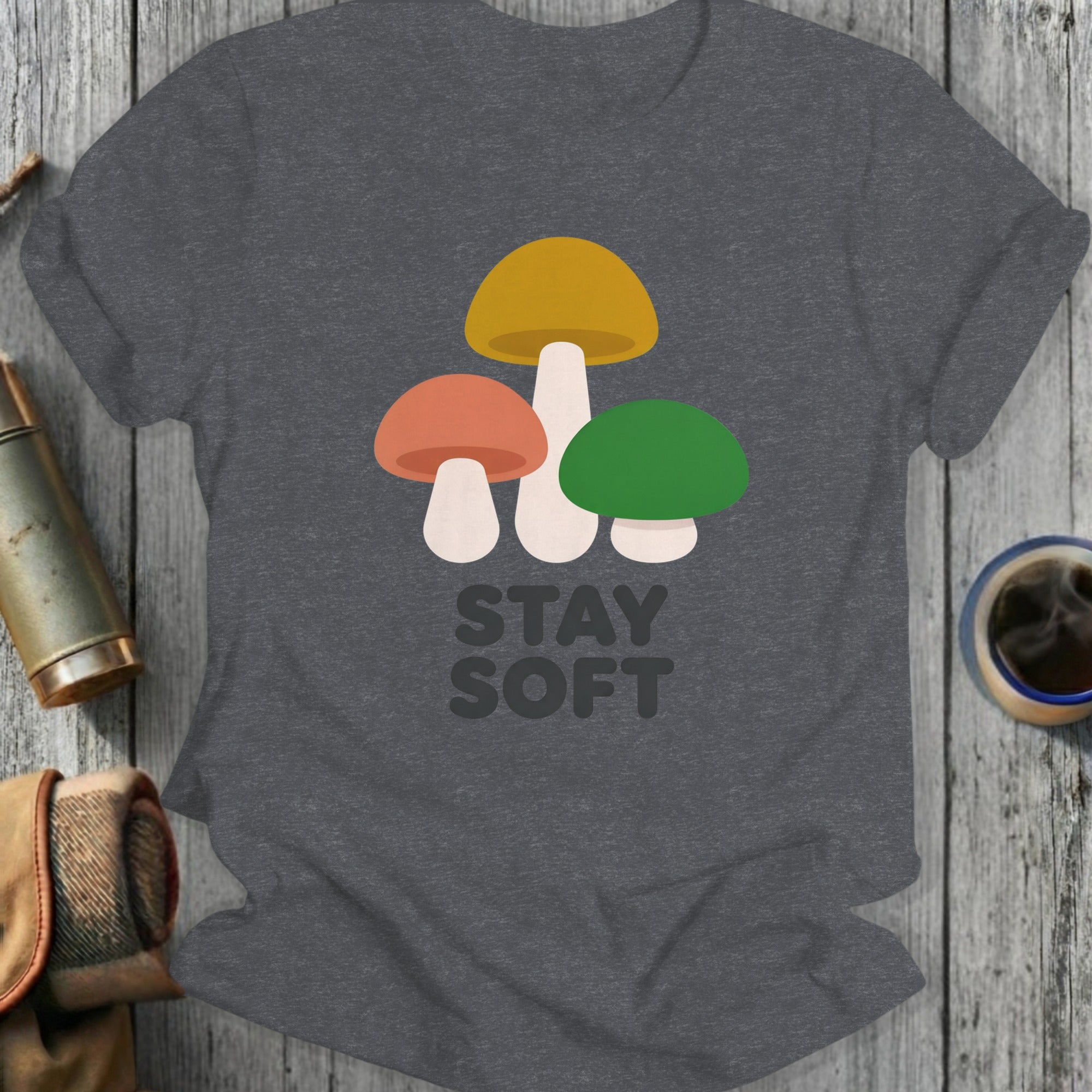 Dark grey t-shirt with three colorful mushrooms and text that reads "STAY SOFT".