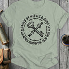 T-shirt with "Raised by Wolves & Cable TV Outdoor Survivor" text and crossed key graphic.