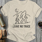 Alien and Bigfoot walk across mountains under a crescent moon, "LEAVE NO TRACE".