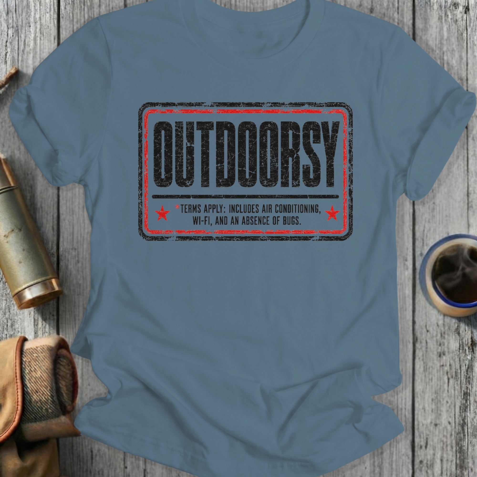Blue t-shirt with "OUTDOORSY TERMS APPLY: INCLUDES AIR CONDITIONING, WI-FI, AND AN ABSENCE OF BUGS."