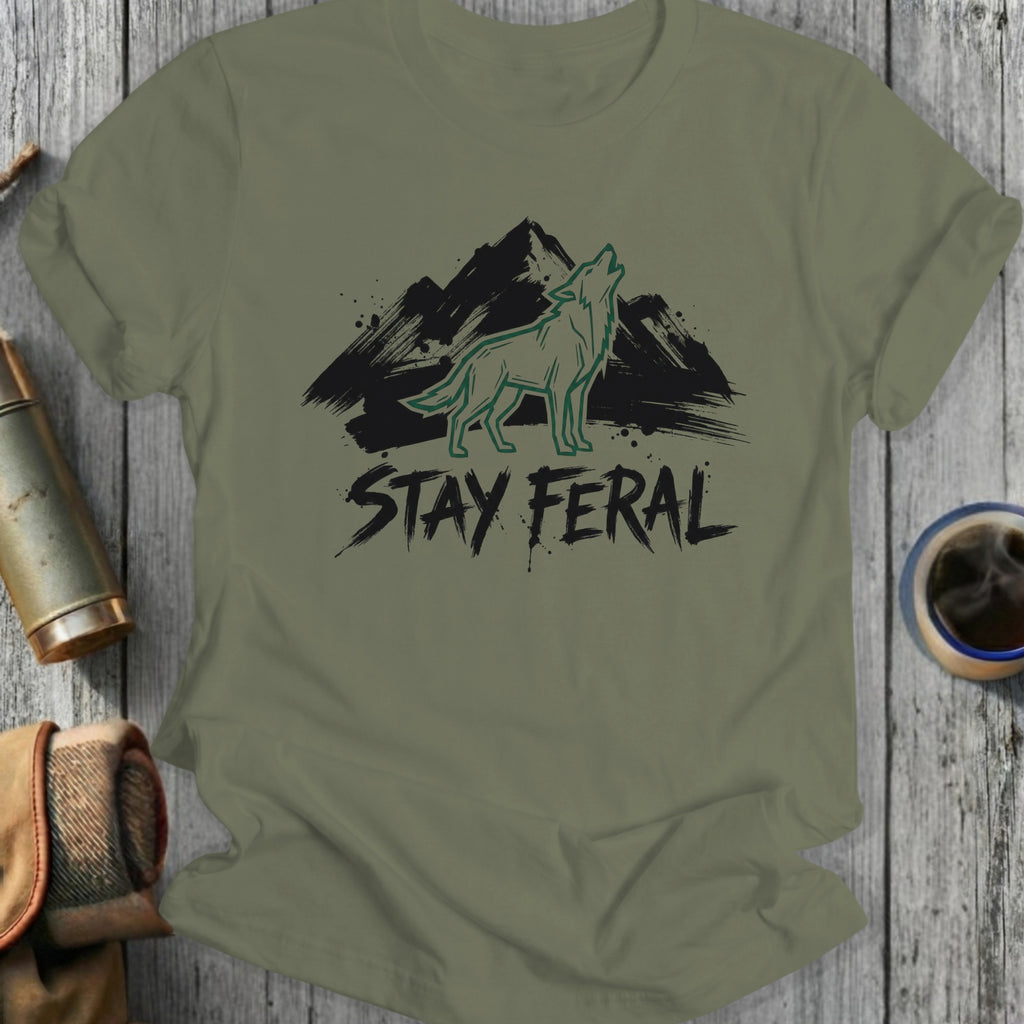 Olive green t-shirt with black mountain and howling wolf graphic, "STAY FERAL" text.