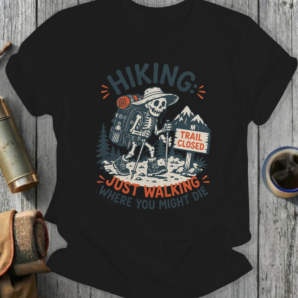 Skeleton hiker on a trail with "Trail Closed" sign, text "Hiking: Just Walking Where You Might Die".