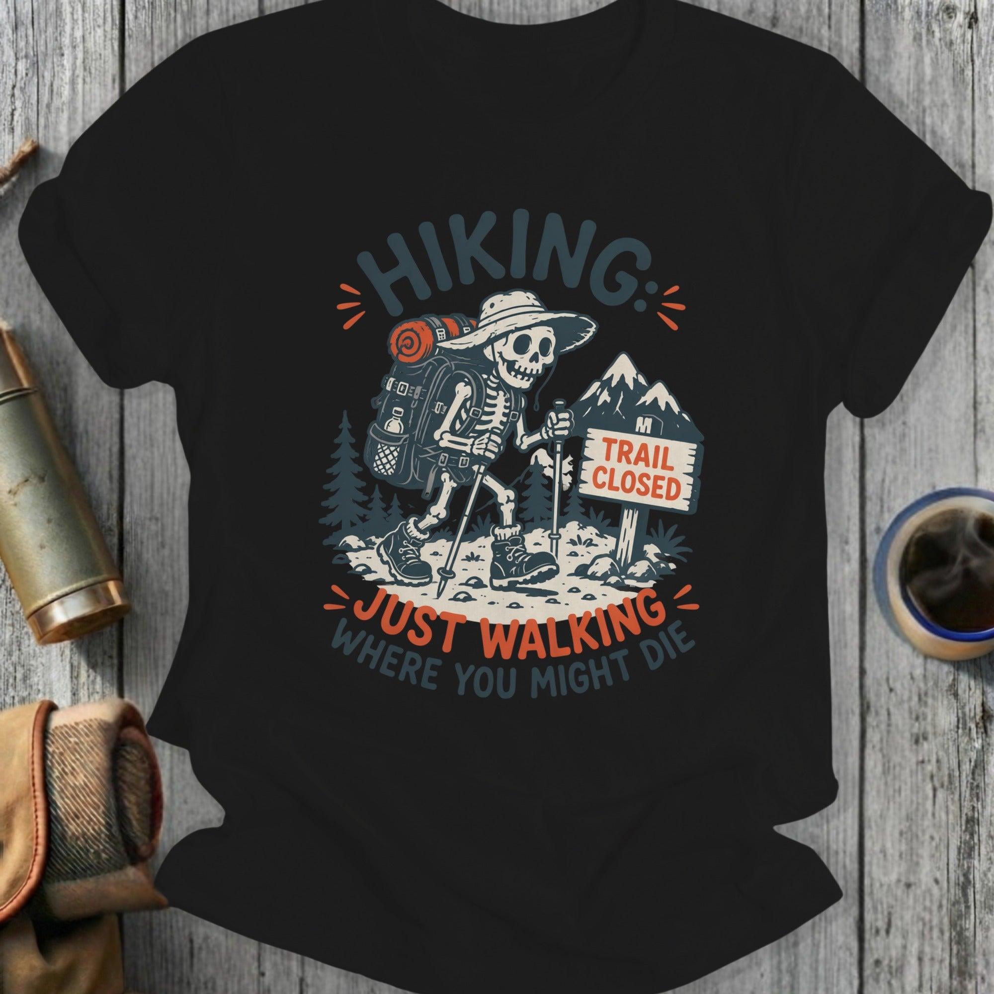 Skeleton hiker on a trail with "Trail Closed" sign, text "Hiking: Just Walking Where You Might Die".