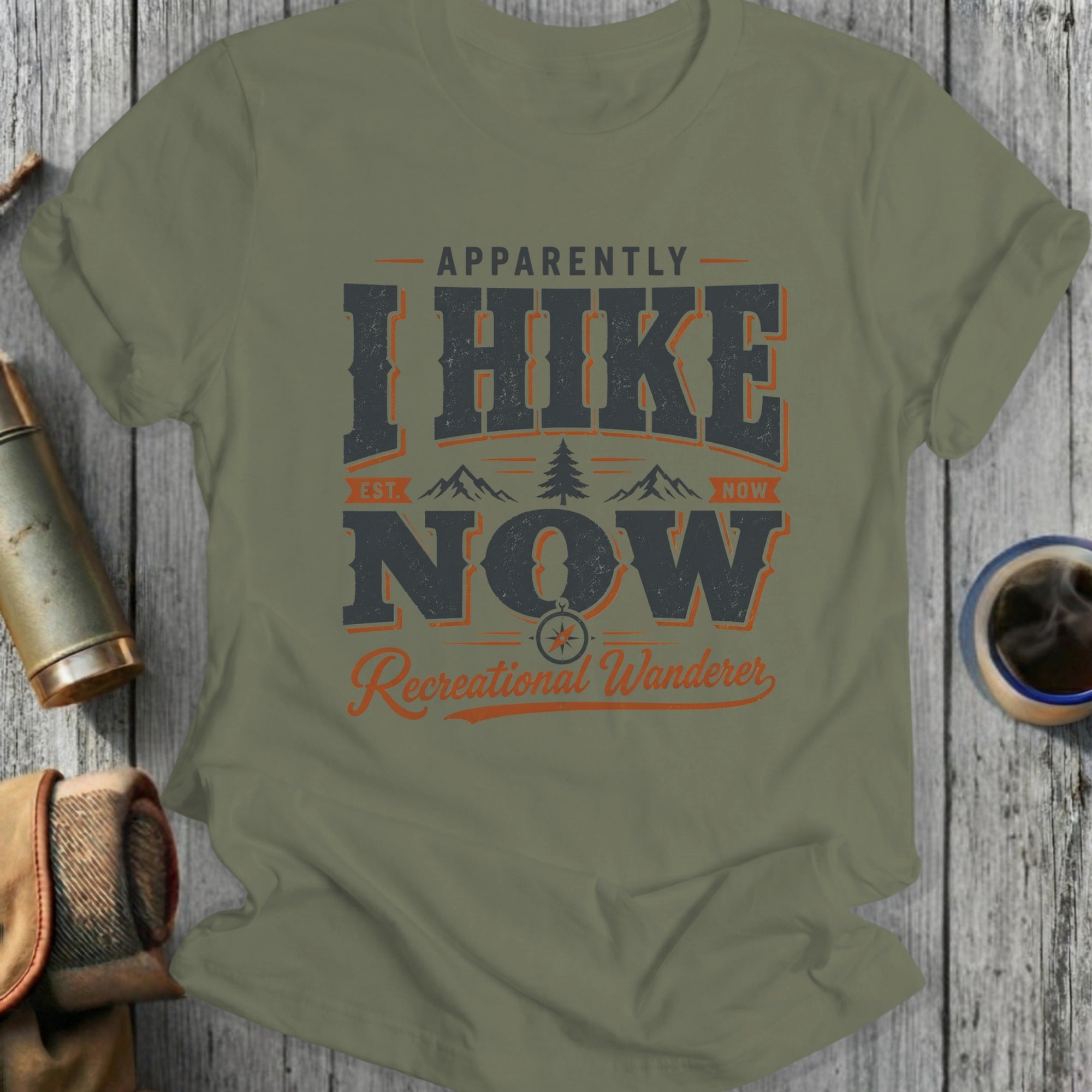 T-shirt with "Apparently I Hike Now, Est. Now, Recreational Wanderer" text and mountains.