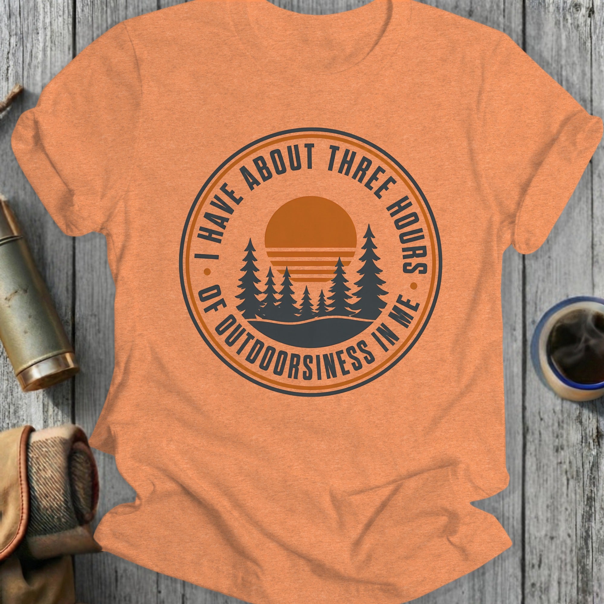 Orange t-shirt with a circular graphic reading "I have about three hours of outdoorsiness in me."