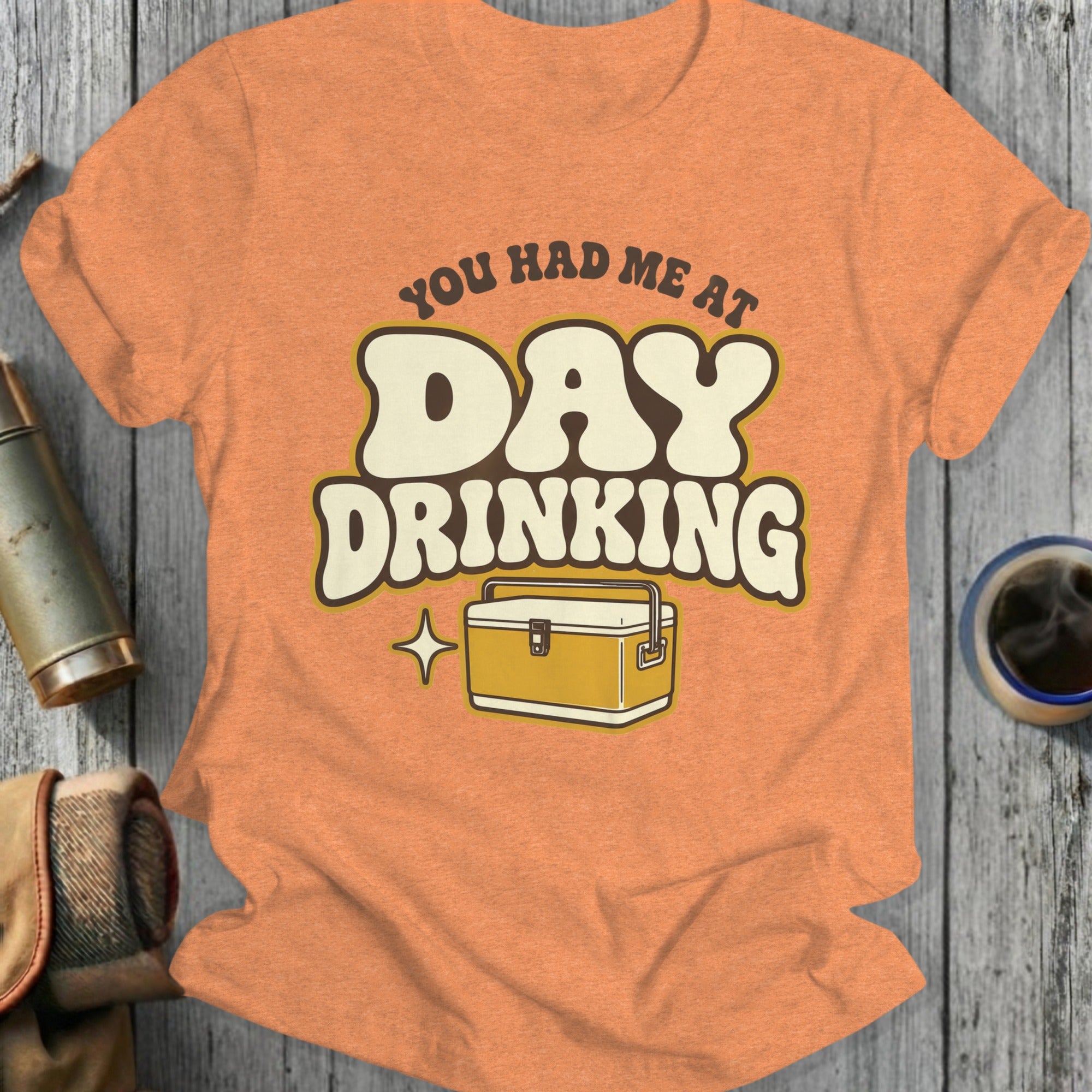 Orange t-shirt with "You Had Me At Day Drinking" text and cooler graphic.