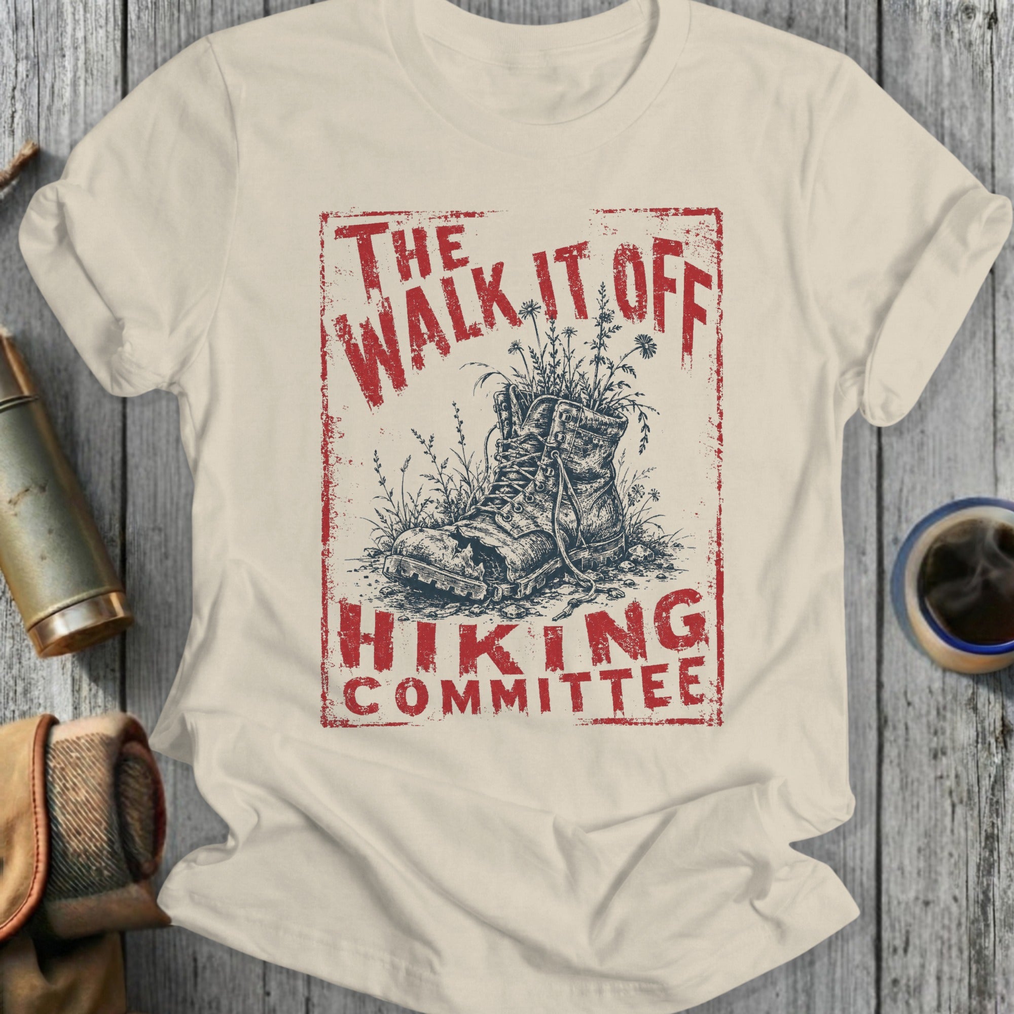 Cream t-shirt with distressed red graphic: "THE WALK IT OFF HIKING COMMITTEE"