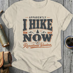 T-shirt with "Apparently I Hike Now Recreational Wanderer" text, mountains, and compass.