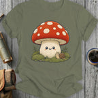 Cute mushroom and snail illustration on a sage green t-shirt.
