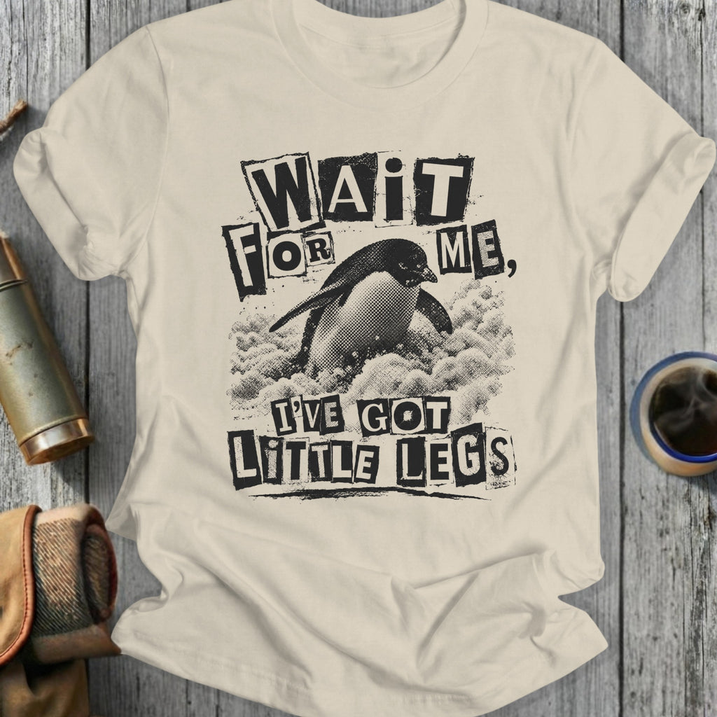 Cream t-shirt with a distressed graphic of a penguin and the text "Wait for me, I've got little legs".