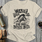 Cream t-shirt with a distressed graphic of a penguin and the text "Wait for me, I've got little legs".