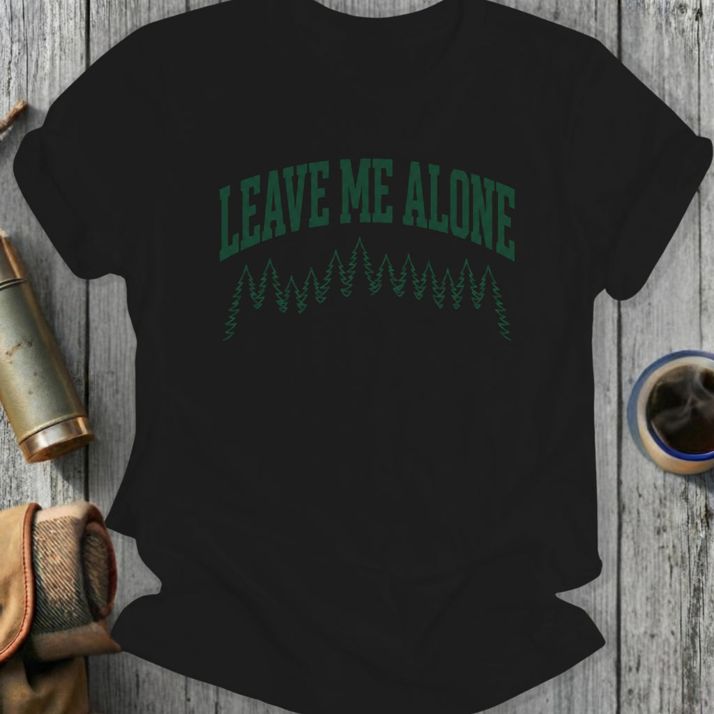 Black t-shirt with green "LEAVE ME ALONE" text and pine trees.