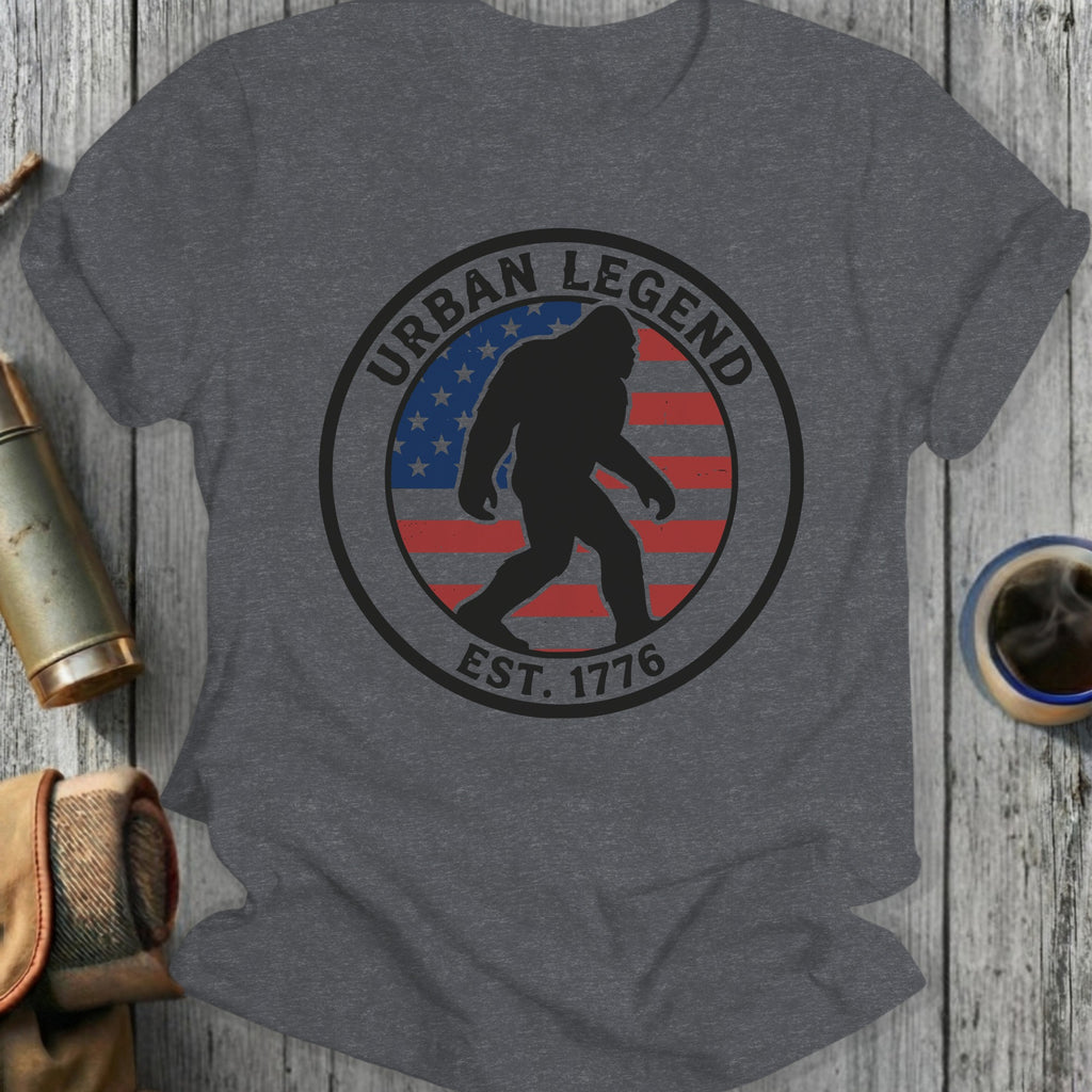 Circular graphic with Bigfoot silhouette inside US flag, "URBAN LEGEND EST. 1776".