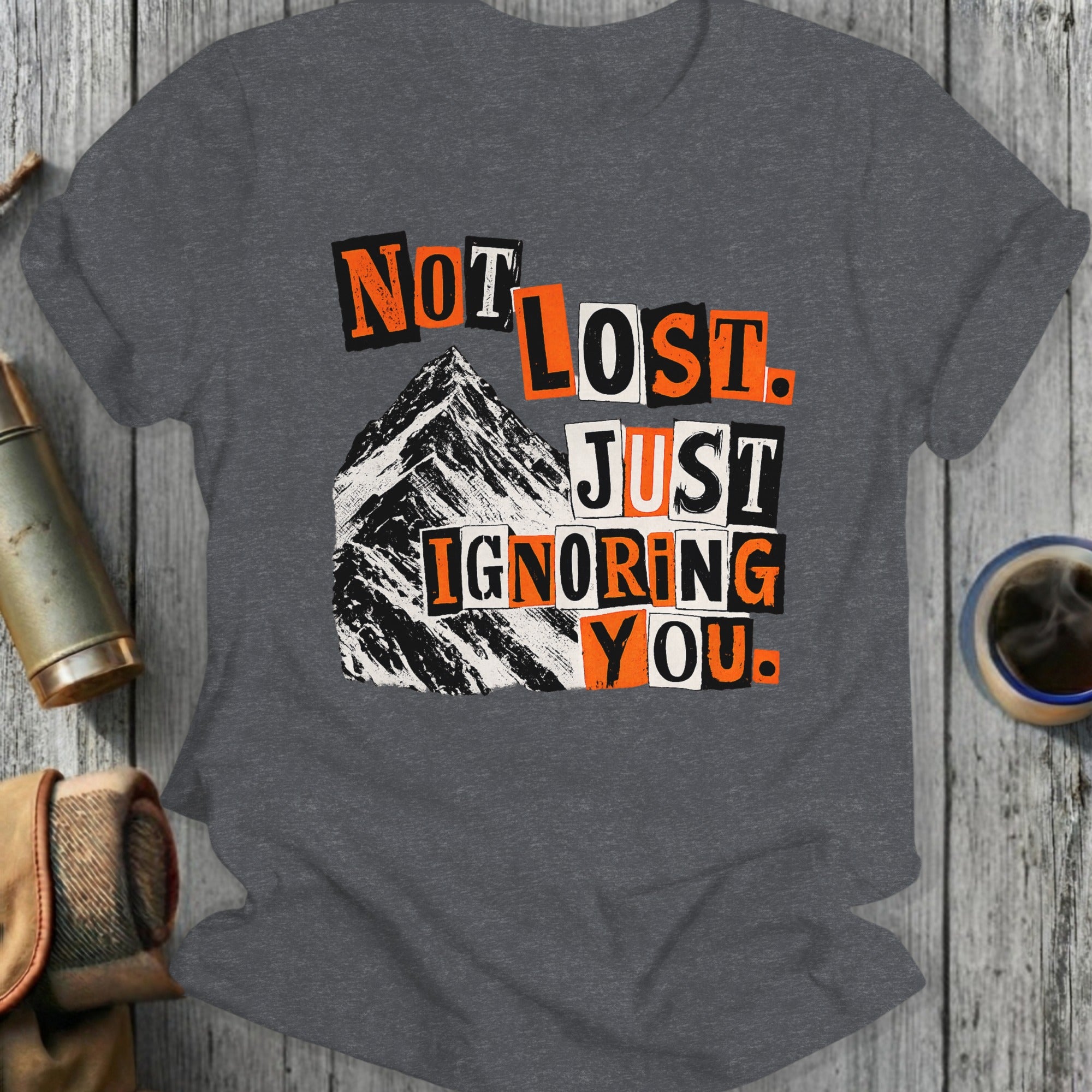 Dark gray t-shirt with "Not Lost. Just Ignoring You." mountain graphic.