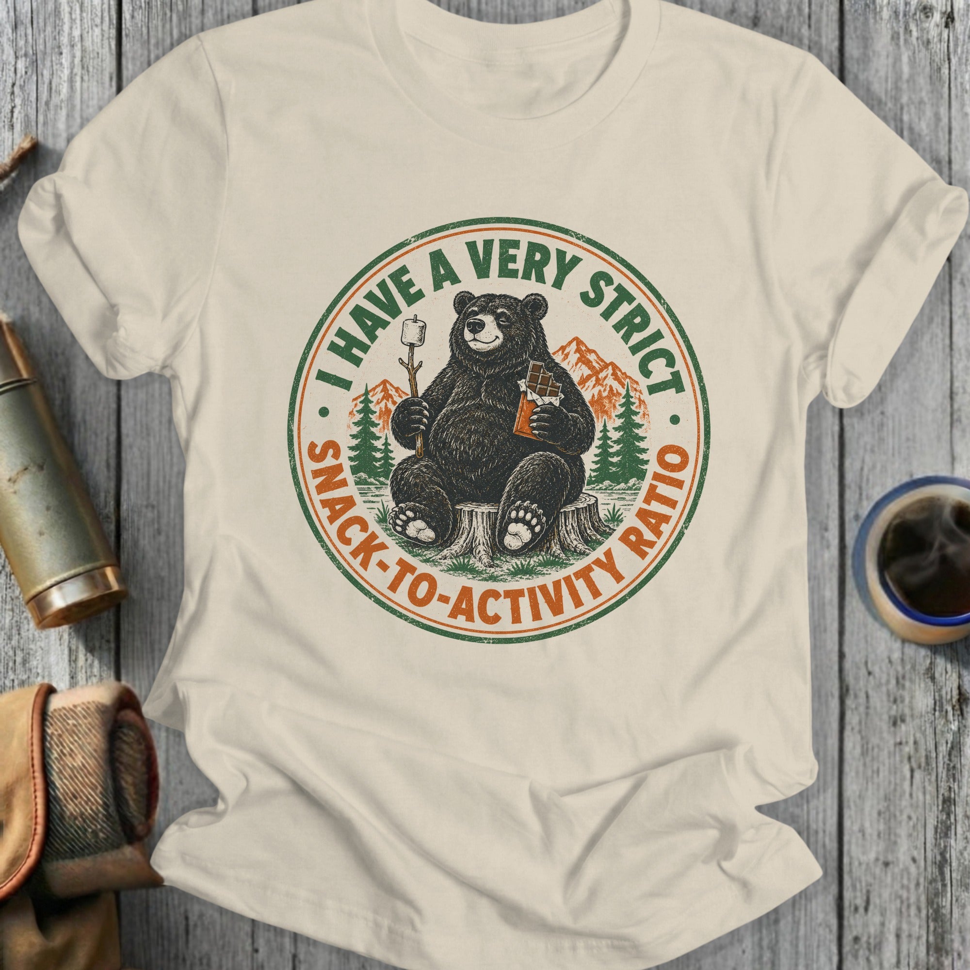 Bear holding marshmallow on stick and chocolate bar, with text "I HAVE A VERY STRICT SNACK-TO-ACTIVITY RATIO".
