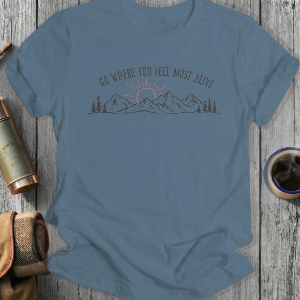 Blue t-shirt with a graphic of "GO WHERE YOU FEEL MOST ALIVE" over mountains.