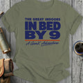 Green t-shirt with bold blue text "In Bed By 9" and smaller text "The Great Indoors A GenX Adventure".