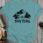 Teal t-shirt with howling wolf and mountains, "STAY FERAL" text.