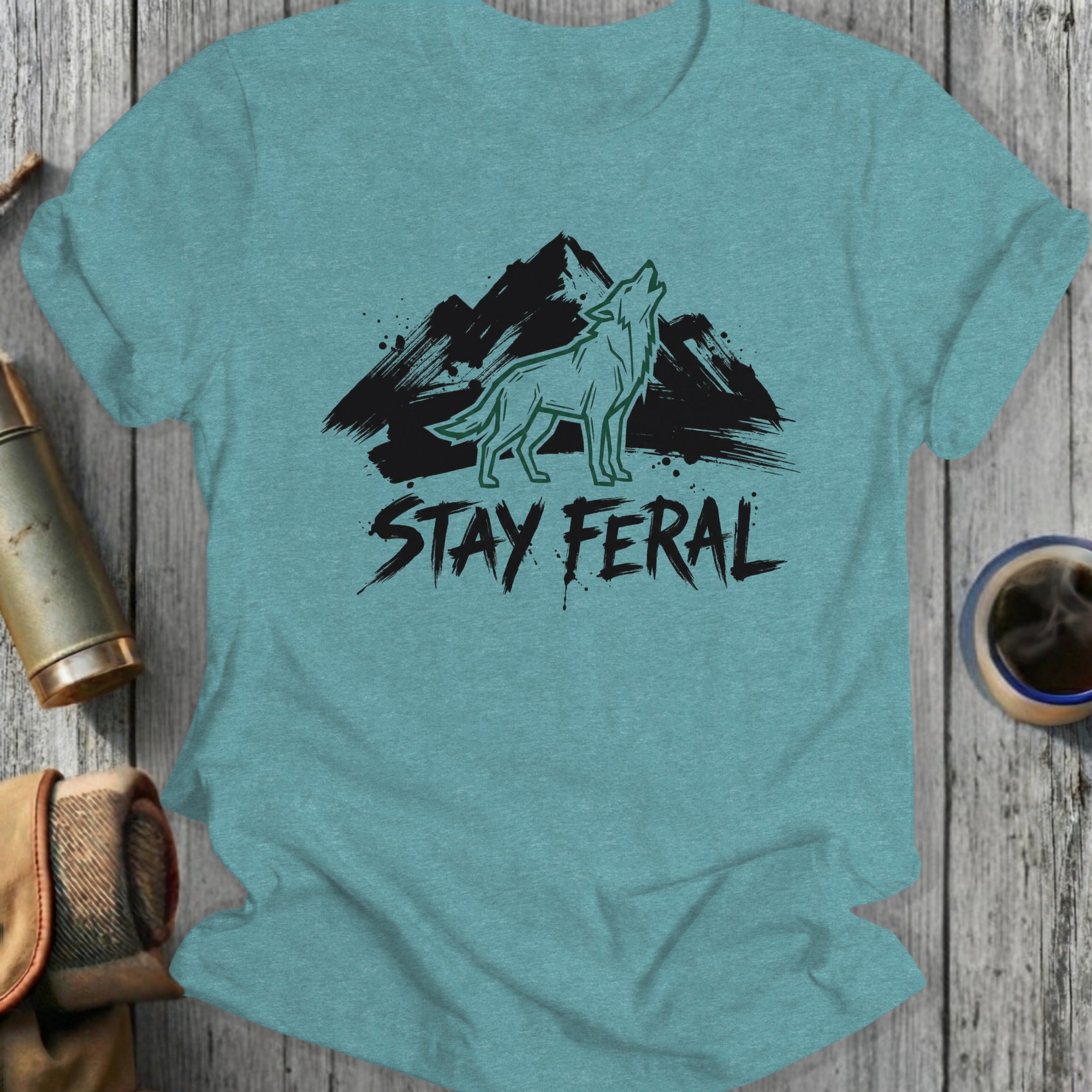 Teal t-shirt with howling wolf and mountains, "STAY FERAL" text.