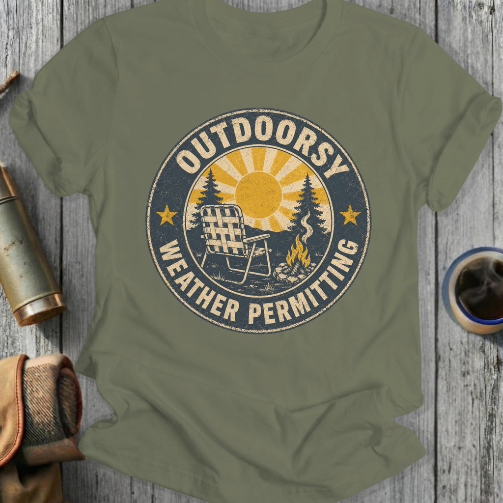 Green t-shirt with "Outdoorsy Weather Permitting" graphic featuring a campfire and chair.