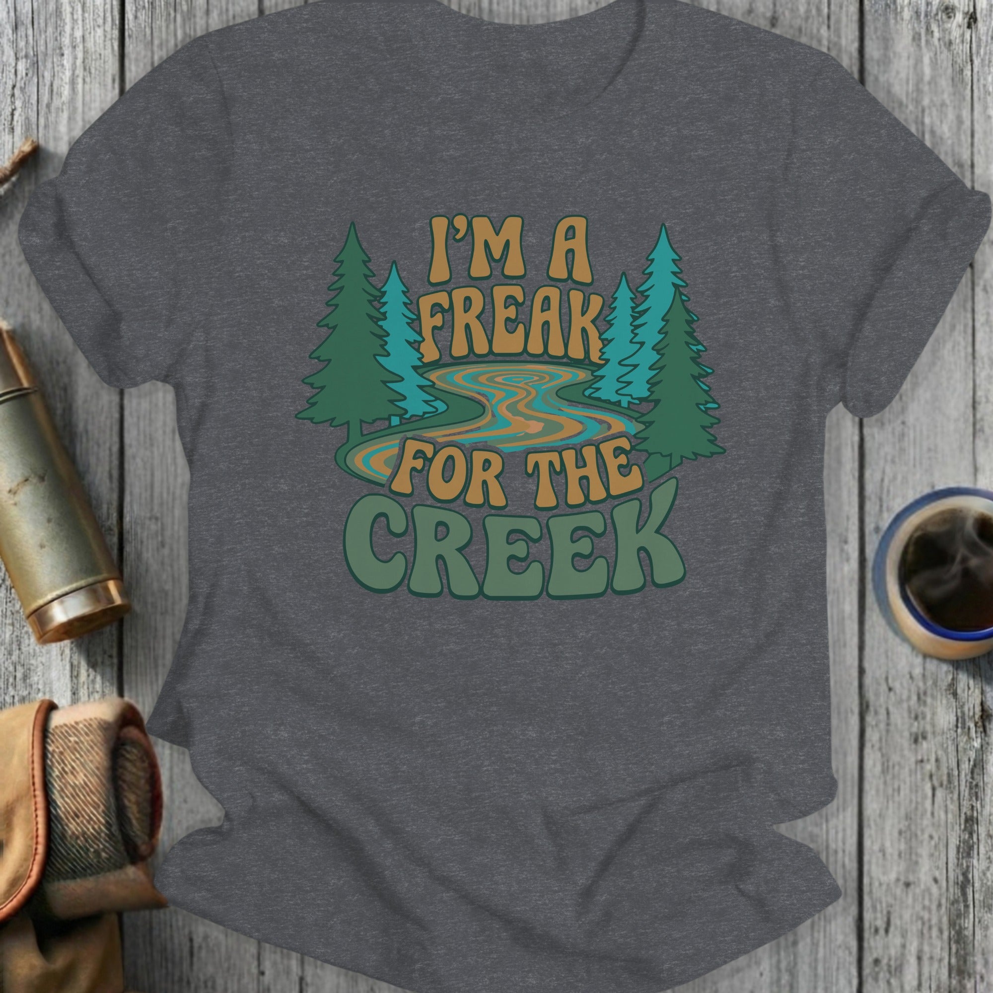 "I'm a freak for the creek" text with trees and river on a t-shirt.