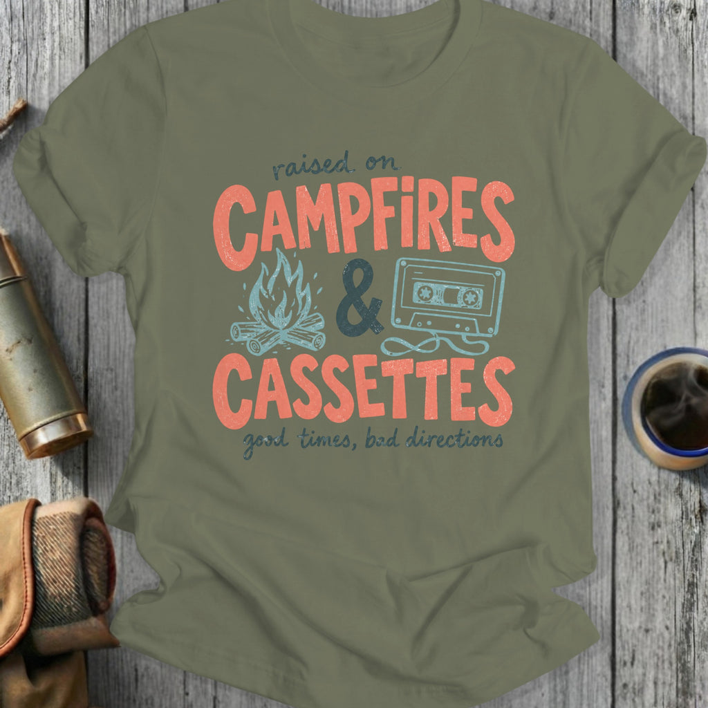 Olive green t-shirt with "raised on CAMPFIRES & CASSETTES good times, bad directions" text.