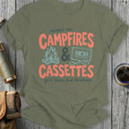 Olive green t-shirt with "raised on CAMPFIRES & CASSETTES good times, bad directions" text.
