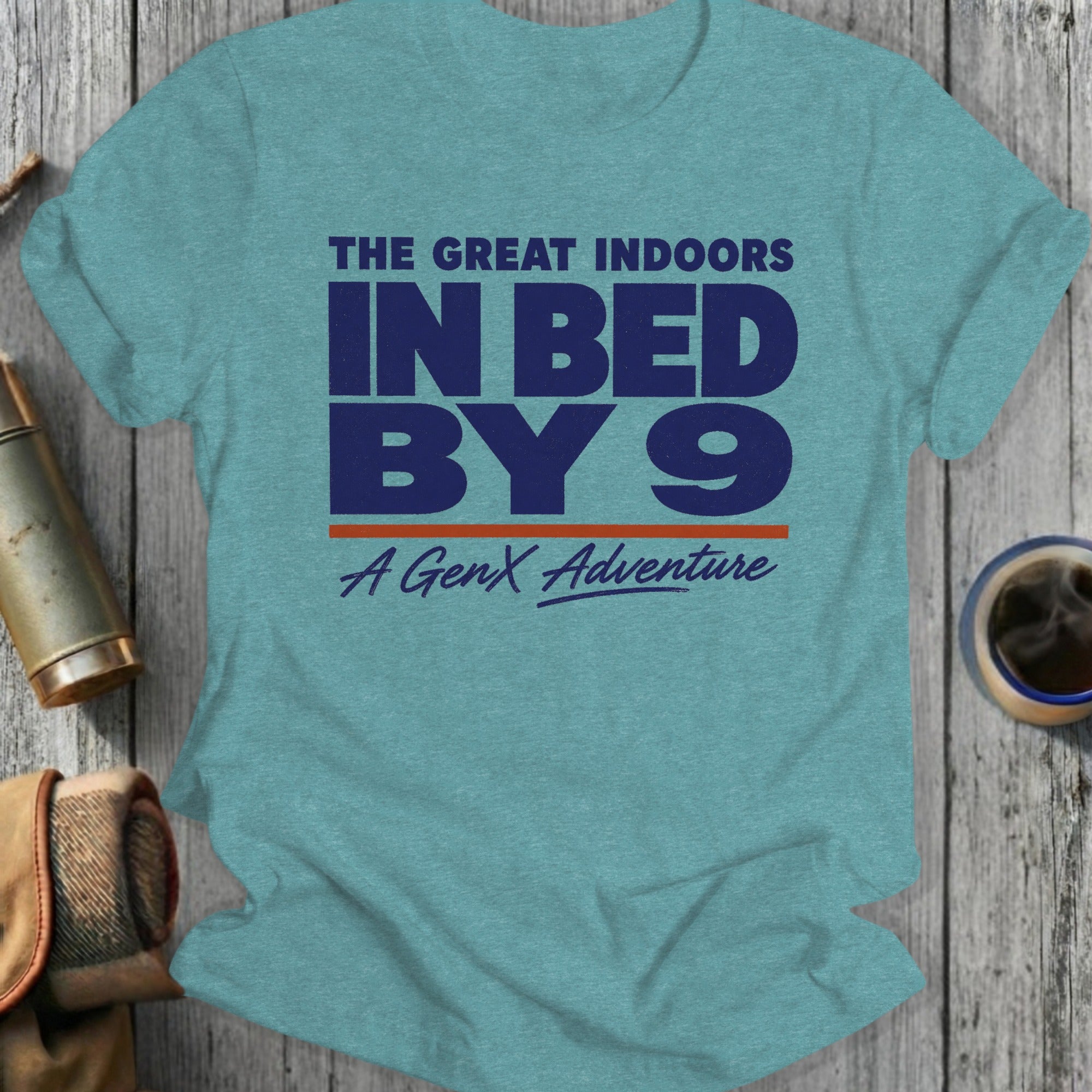 Teal t-shirt with "The Great Indoors In Bed By 9 A GenX Adventure" text.