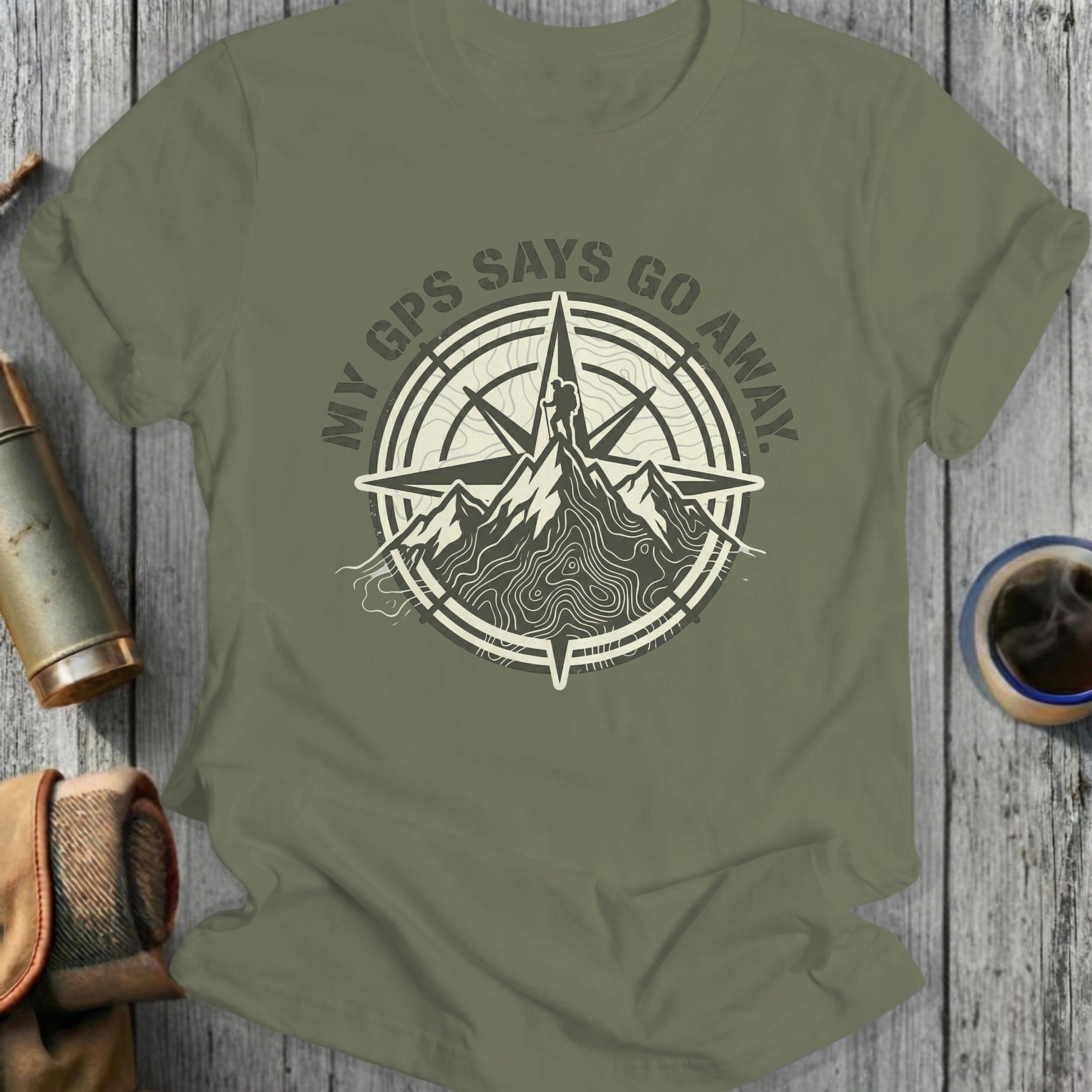 Green t-shirt with compass and mountain graphic, text reads "MY GPS SAYS GO AWAY."