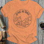 Bigfoot and alien sit by campfire with "Leave No Trace" text around circle.