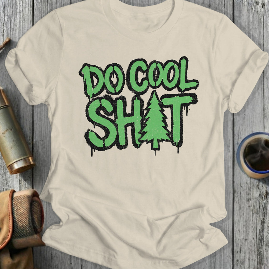 Cream t-shirt with "DO COOL SH*T" and a Christmas tree graphic.