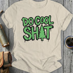 Cream t-shirt with "DO COOL SH*T" and a Christmas tree graphic.