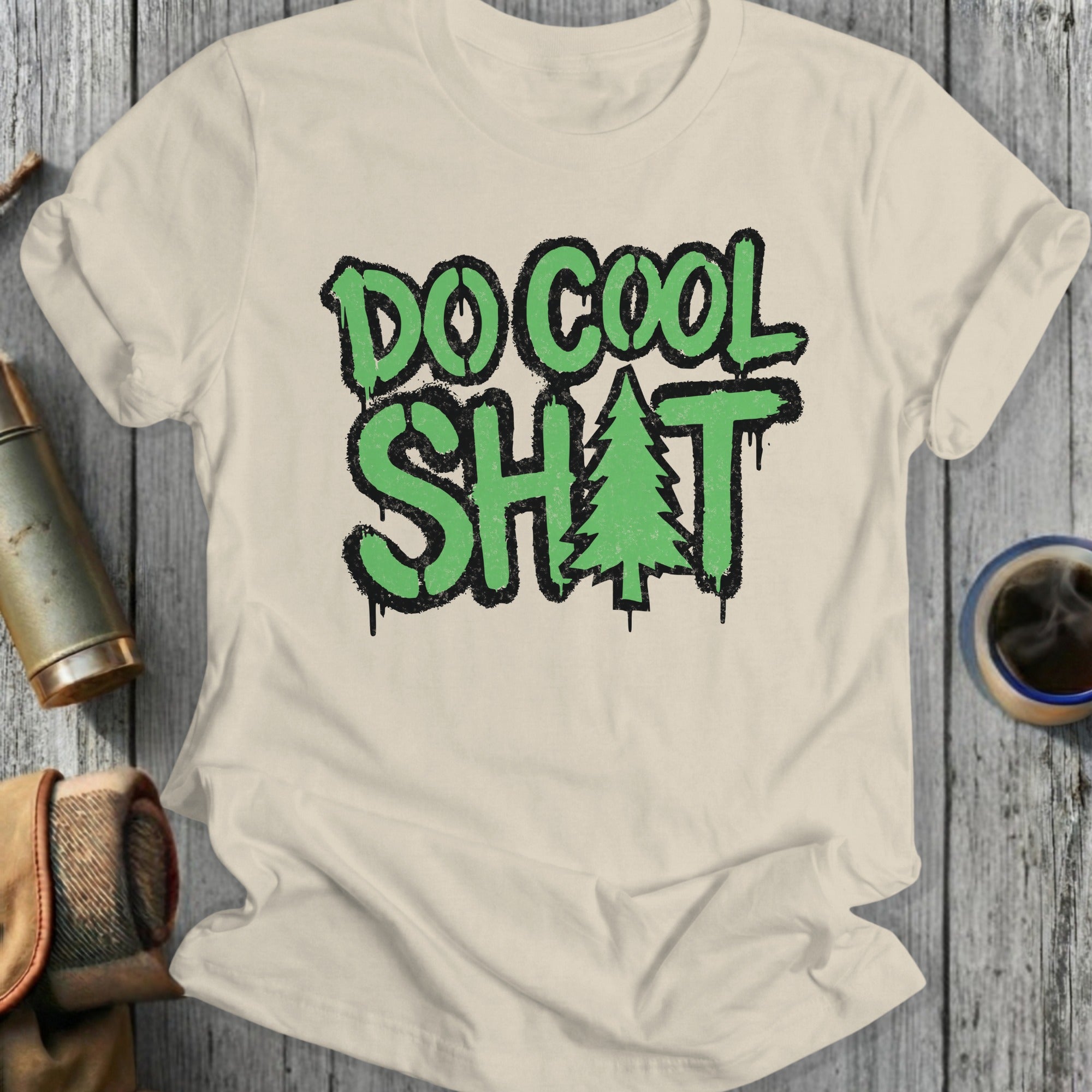 Cream t-shirt with "DO COOL SH*T" and a Christmas tree graphic.