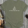 Olive t-shirt with a white campfire graphic and text "a little burned out."