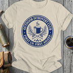 Cream t-shirt with blue circular graphic: "Outdoor Introvert Club First Up. First Asleep."