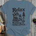 T-shirt graphic with raccoon relaxing, holding coffee and text "Relax Nothing is under control".