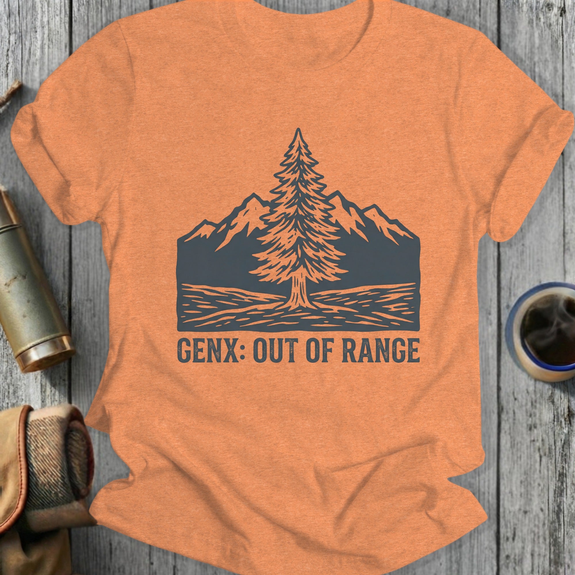 Orange t-shirt with a pine tree and mountains graphic and "GENX: OUT OF RANGE" text.