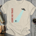 Cream t-shirt with "LEAVE NO TRACE" and Bigfoot being abducted by a UFO.
