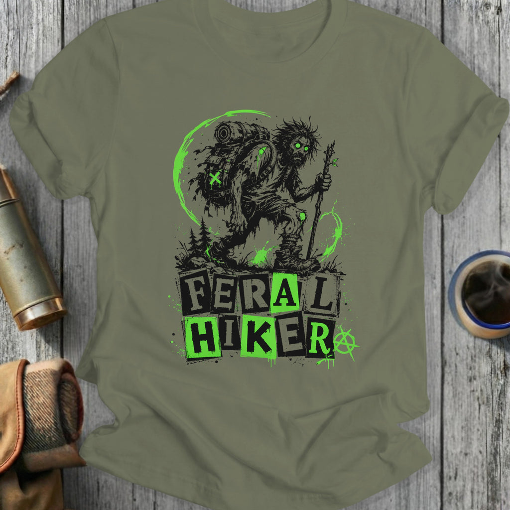 Feral Hiker graphic on olive green t-shirt with backpack and staff.