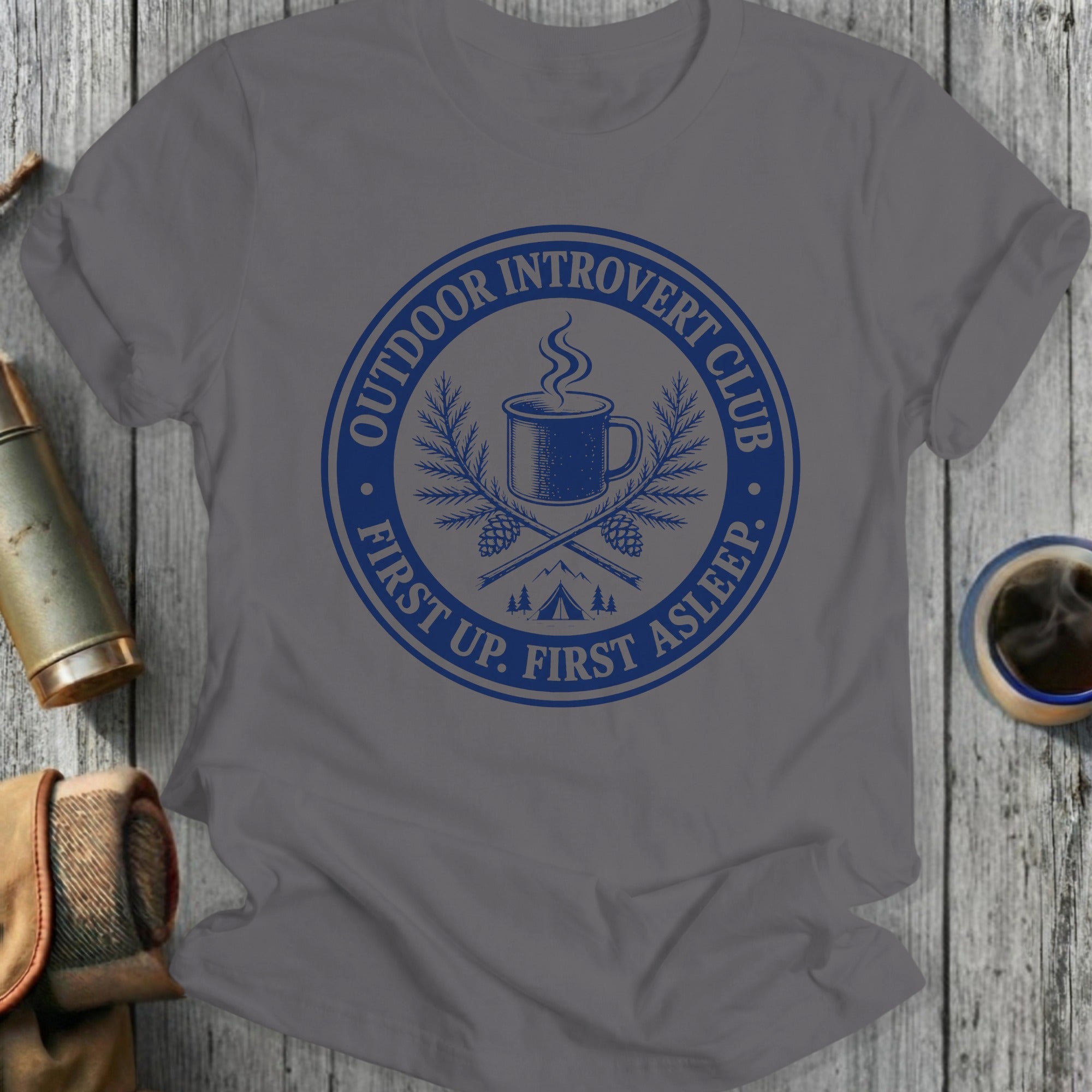 Grey t-shirt with blue circular logo stating "Outdoor Introvert Club First Up. First Asleep."