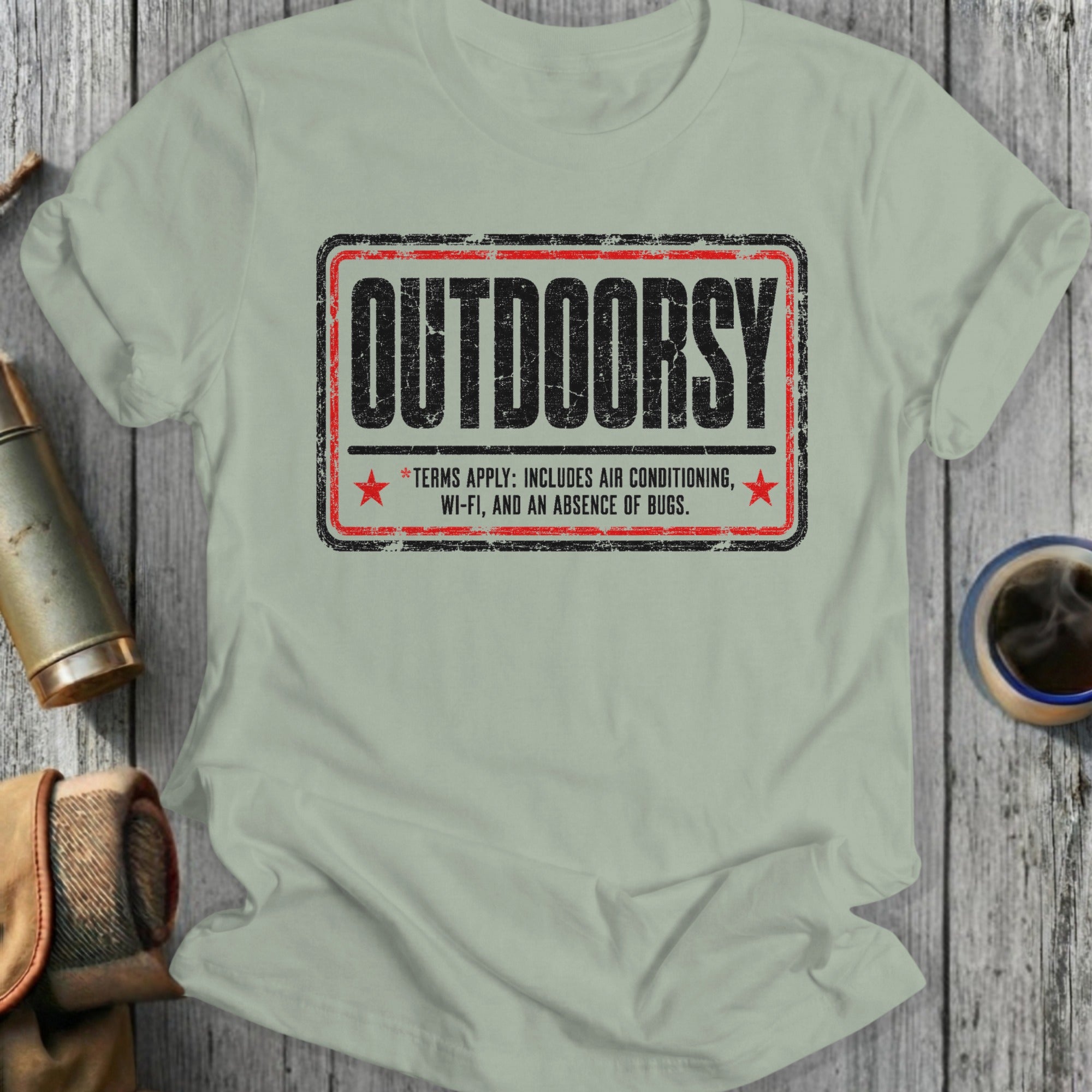 T-shirt with "OUTDOORSY" text and terms including air conditioning and Wi-Fi.