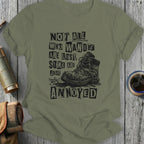 Olive t-shirt with distressed boots and "Not all who wander are lost, some are just annoyed" text.