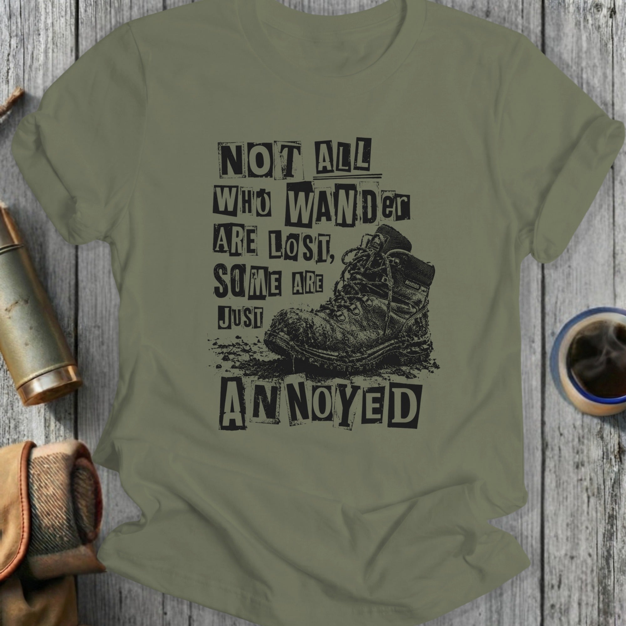 Olive t-shirt with distressed boots and "Not all who wander are lost, some are just annoyed" text.